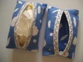 Tissue holders with embroidered openings